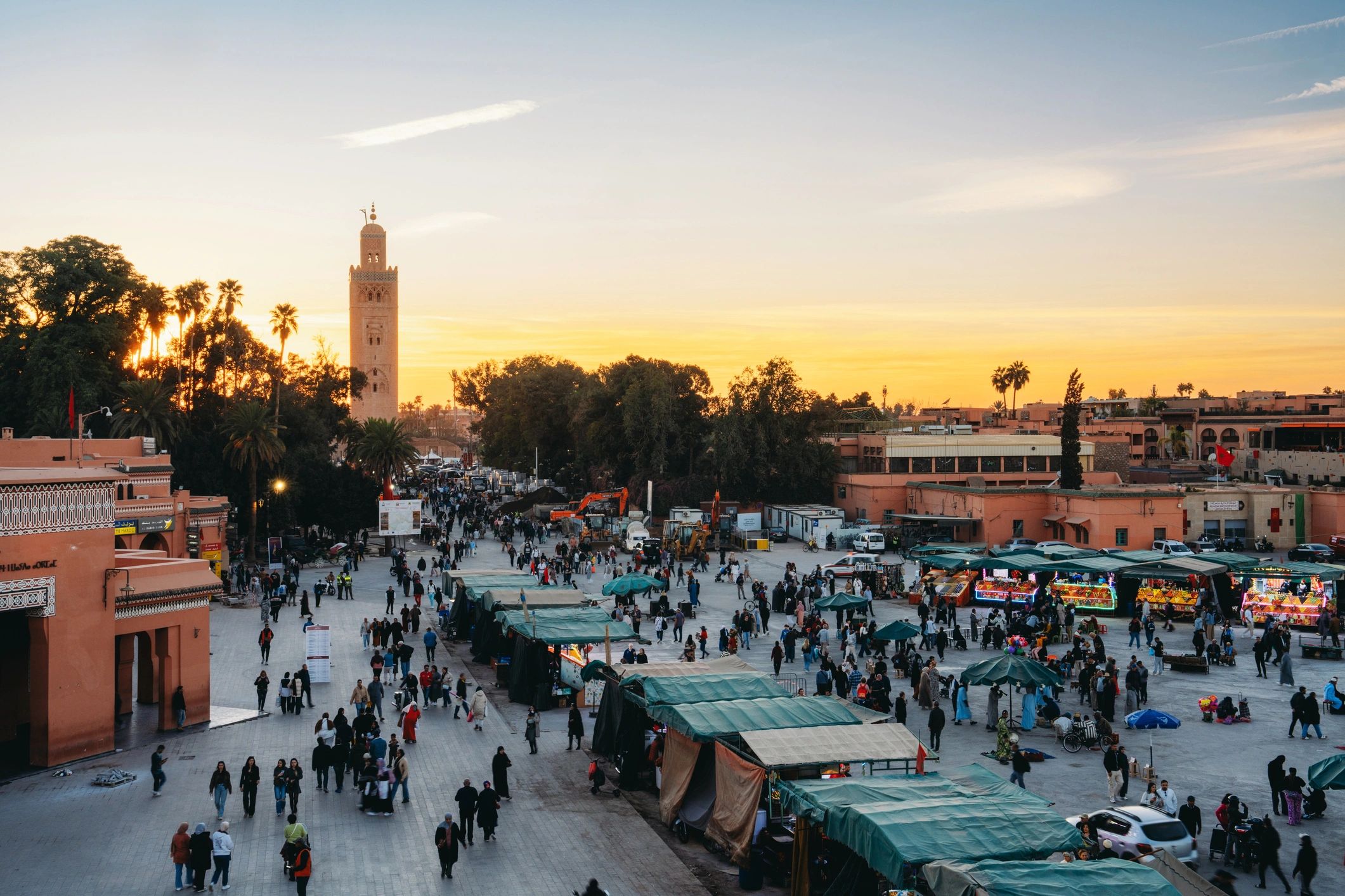 Travelers enjoying a lively North African city setting at sunset
